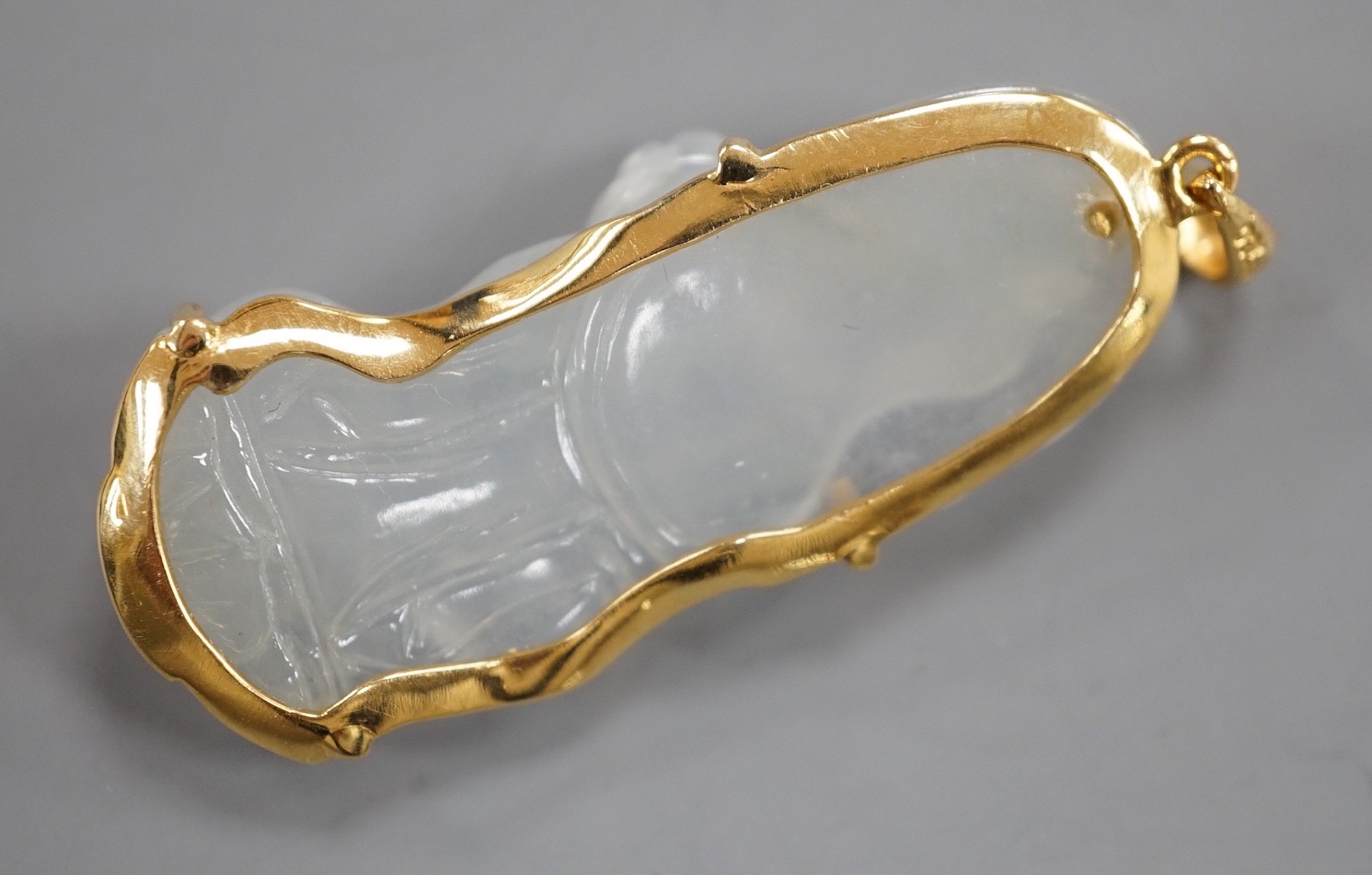 A modern 18k mounted carved jade figural pendant, overall 5cm, gross weight 10.8 grams.